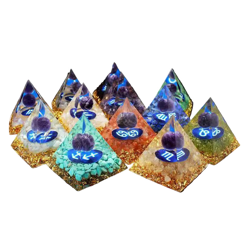 Set of pyramid-shaped decorative items with colorful stones and symbols on a white background