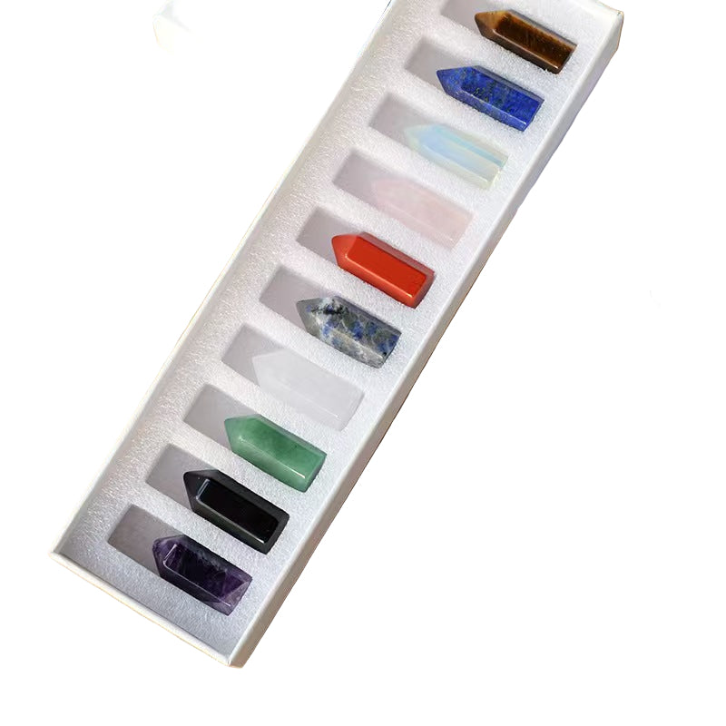 Set of colorful crystal stones in a box on a wooden surface