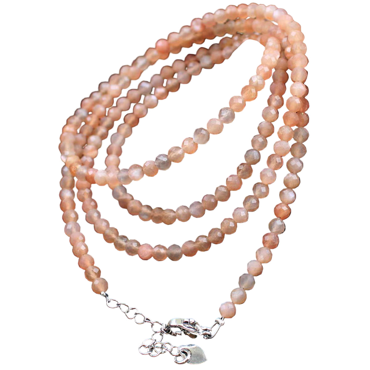 Necklace with pink beads and silver clasp on a light background
