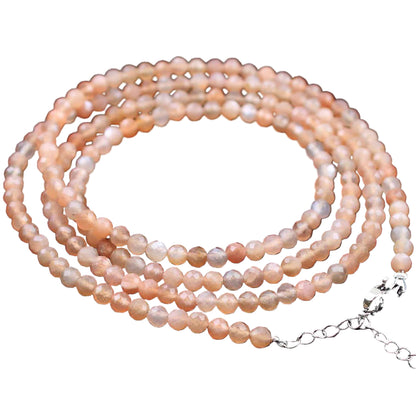 Necklace with pink and white pearls on a white background