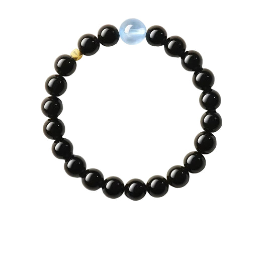 Black beaded bracelet on a light background with floral elements