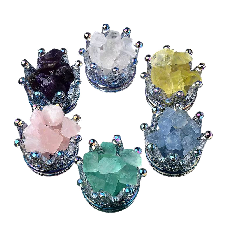 Set of colorful crystal rocks in decorative holders on a white surface.