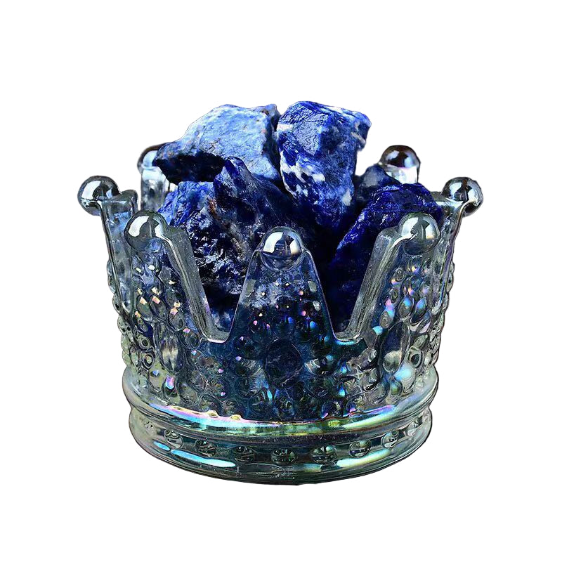 Blue crystal stones in a glass crown on a white background