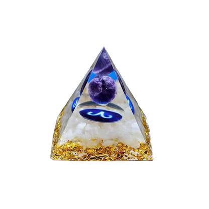 Pyramid-shaped crystal with purple stone and gold base on a white background