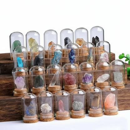 Collection of various crystals in glass domes on a wooden stand.