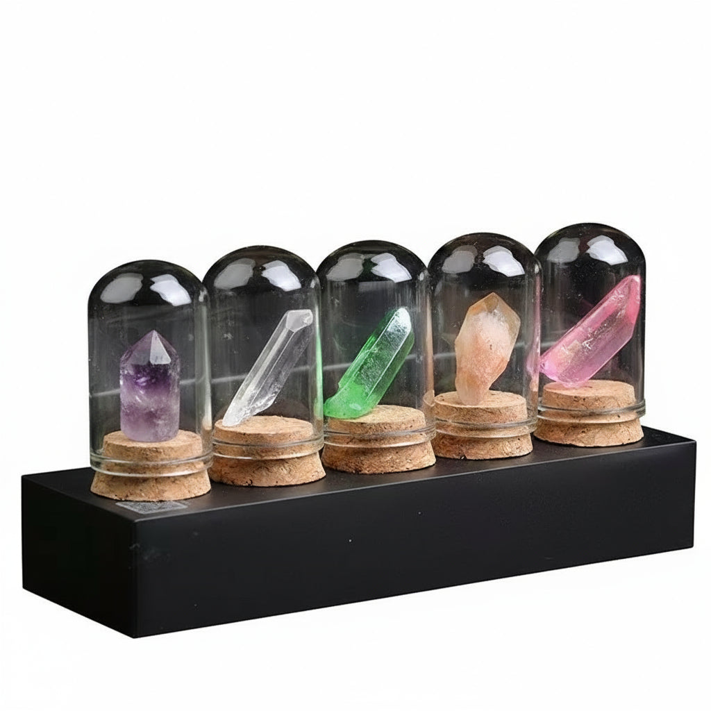 Set of crystal specimens under glass domes on a black platform