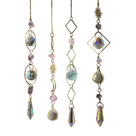 Crystal hanging decorations with gold chains on a blurred background