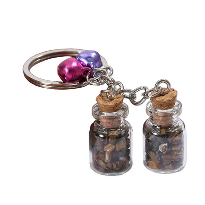 Keychain with small glass jars containing stones 