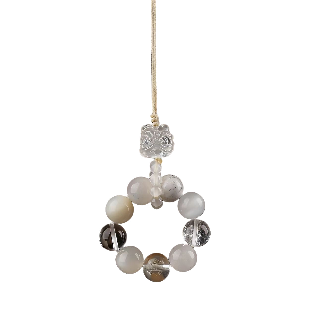 Decorative hanging with beads and a floral element on a dark background