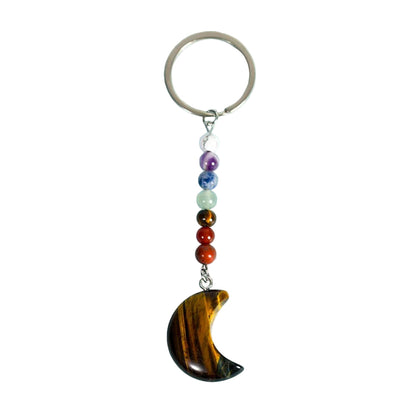 Keychain with a crescent moon pendant and colorful beads on a light blue background