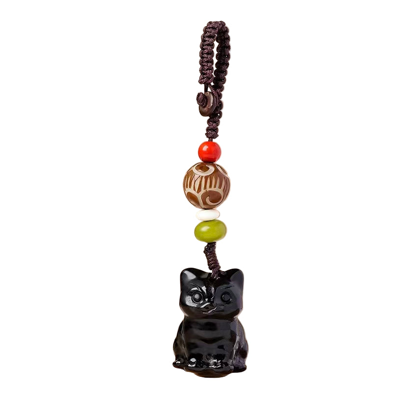 Black cat-shaped ornament with colorful beads on a beige background
