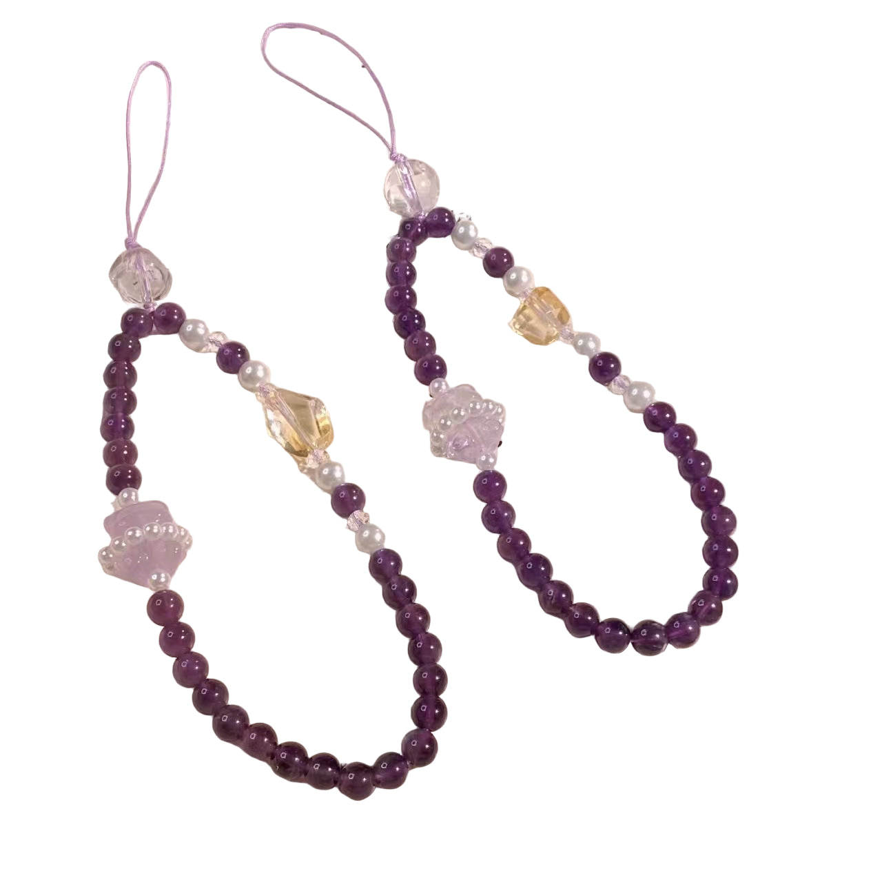 Purple beaded phone charm on a white plate with text