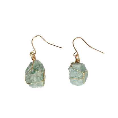 Green stone earrings with gold wire wrapping on a white background