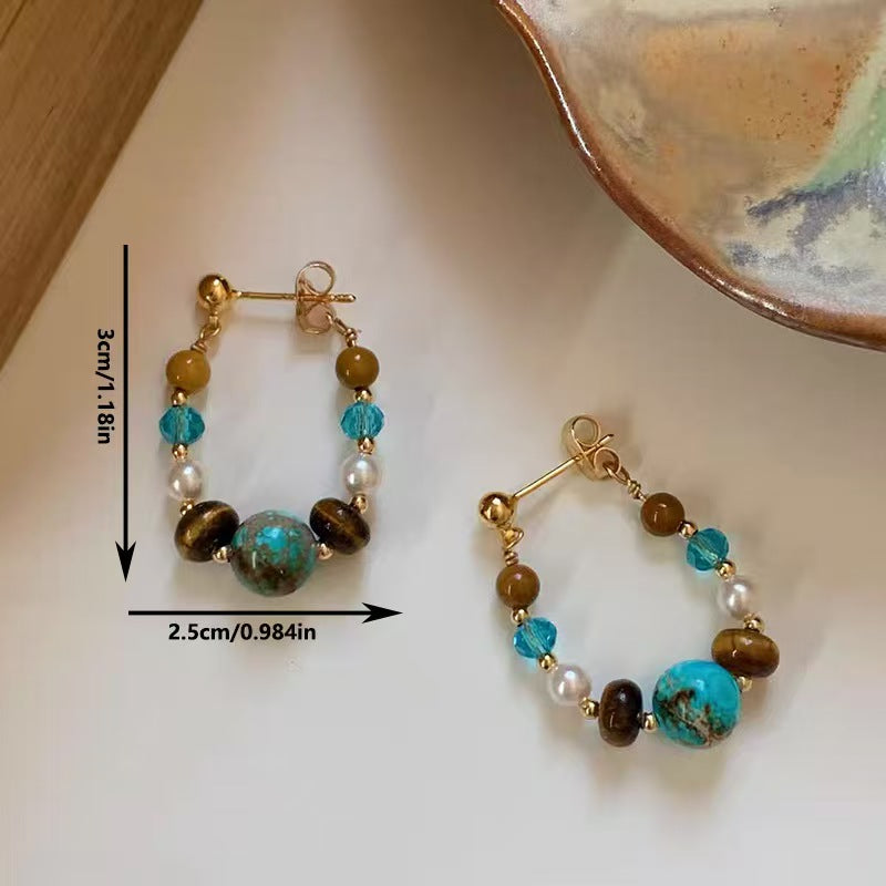Pair of beaded hoop earrings with measurements on a light background