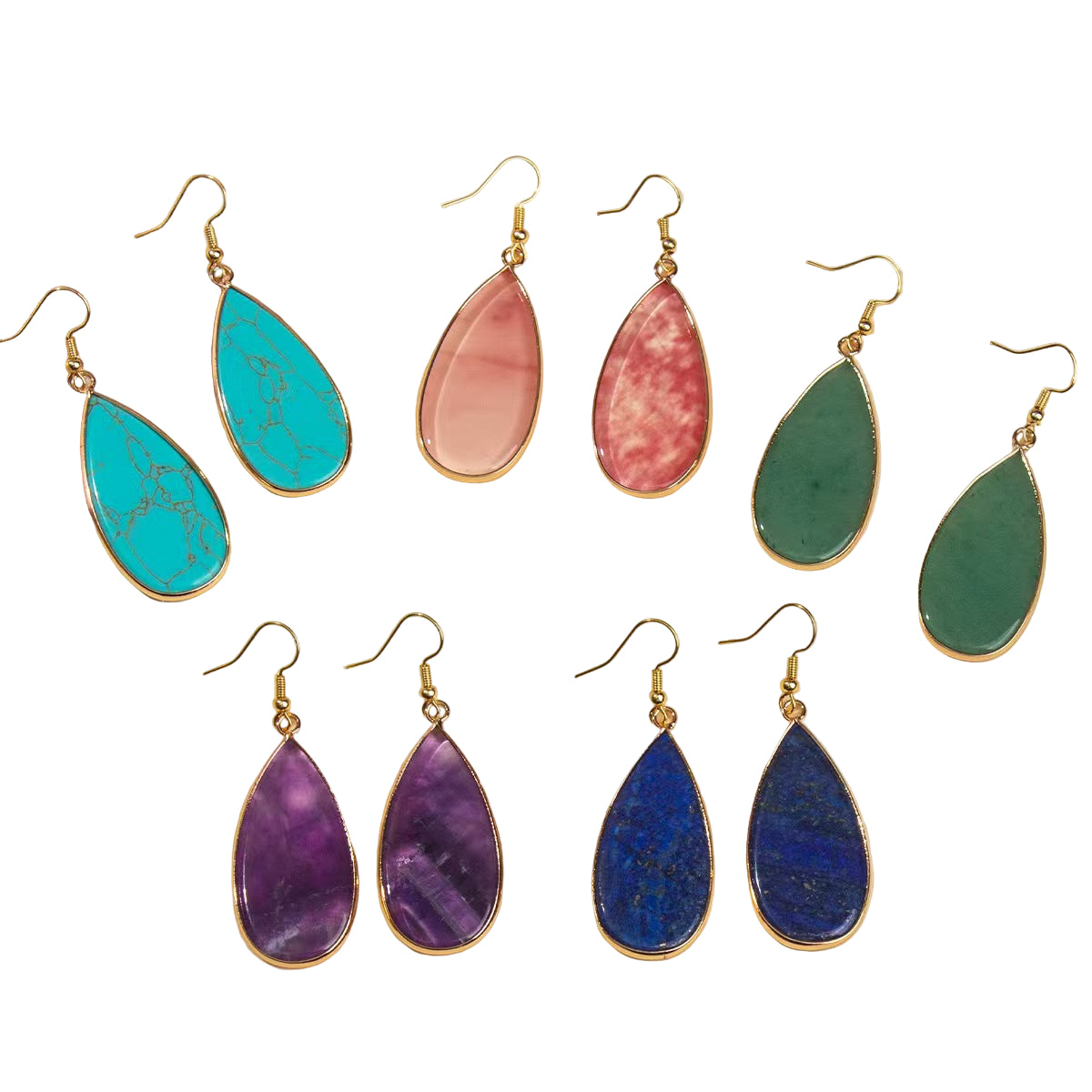 Set of colorful teardrop earrings on a light background