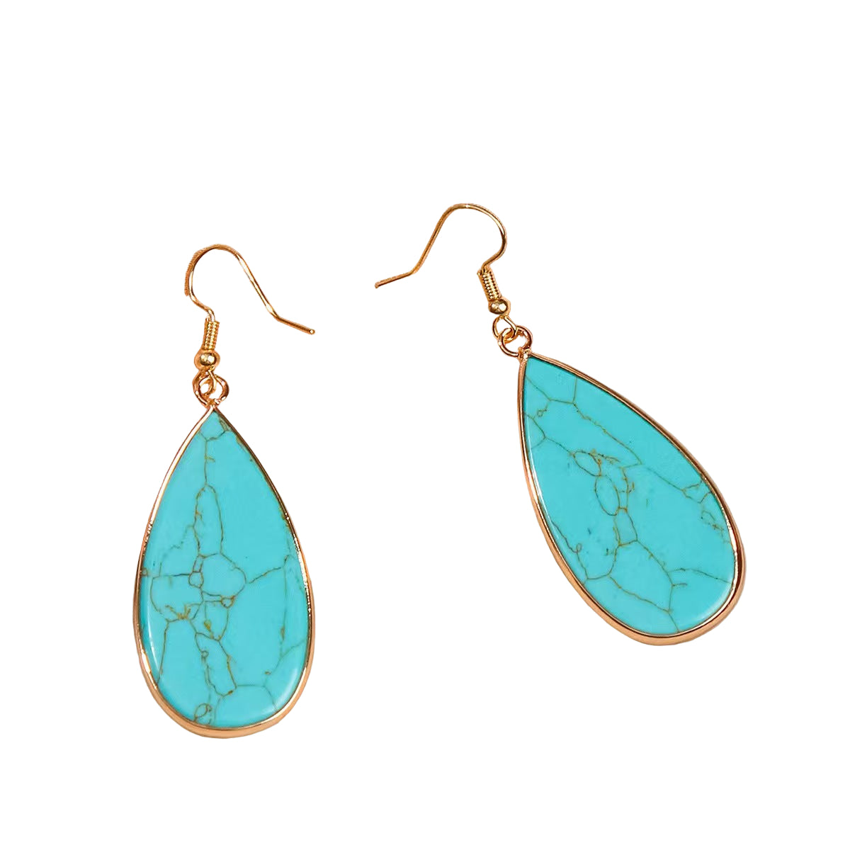 Turquoise teardrop earrings with gold hooks on a beige fabric background