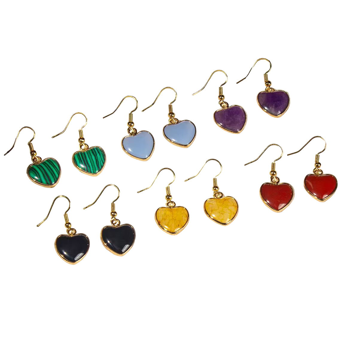 Set of heart-shaped earrings with colorful stones on a white stone surface.