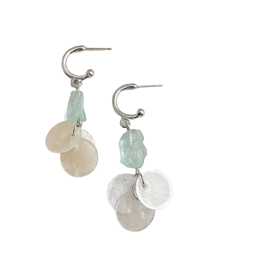 Pair of earrings with stone beads on a white background