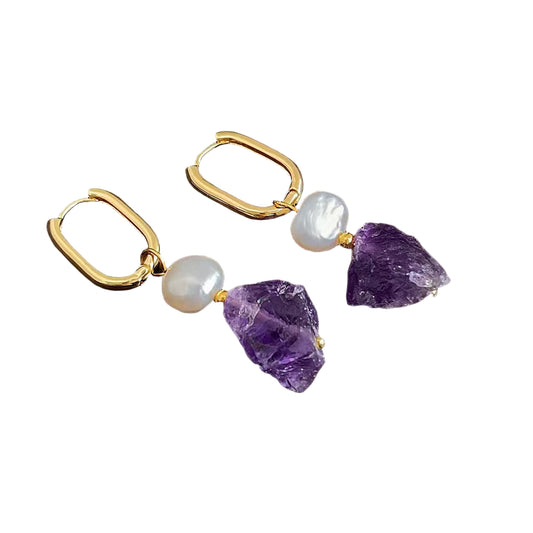 Gold hoop earrings with purple and white stone accents on a white background