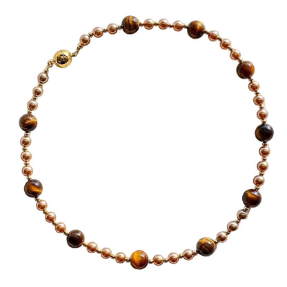 Necklace with brown and gold beads on a white background