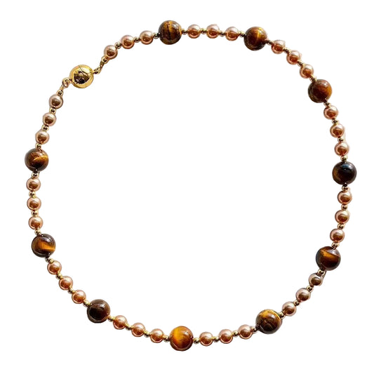 Necklace with brown and gold beads on a white background