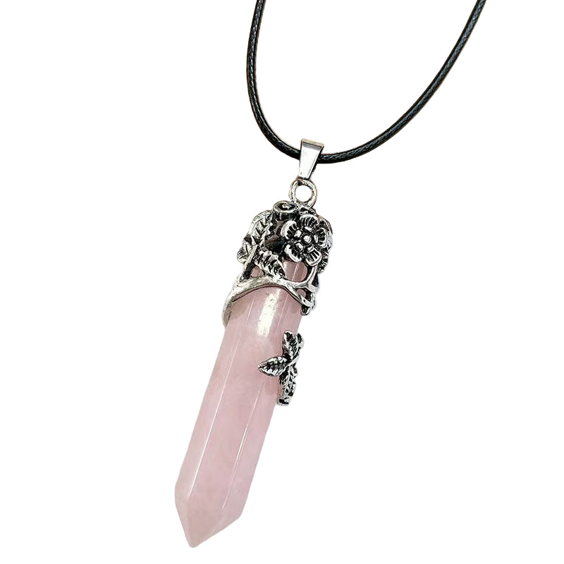 Necklace with a pink pendant and silver decorative elements on a white background