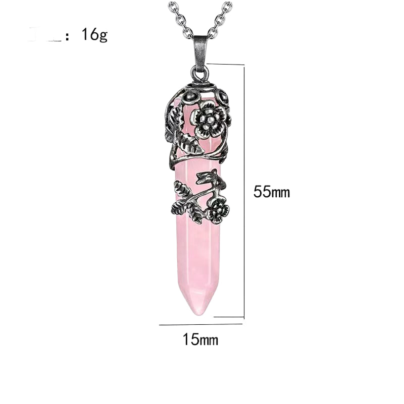 Pink dagger-shaped pendant with silver floral designs on a white background