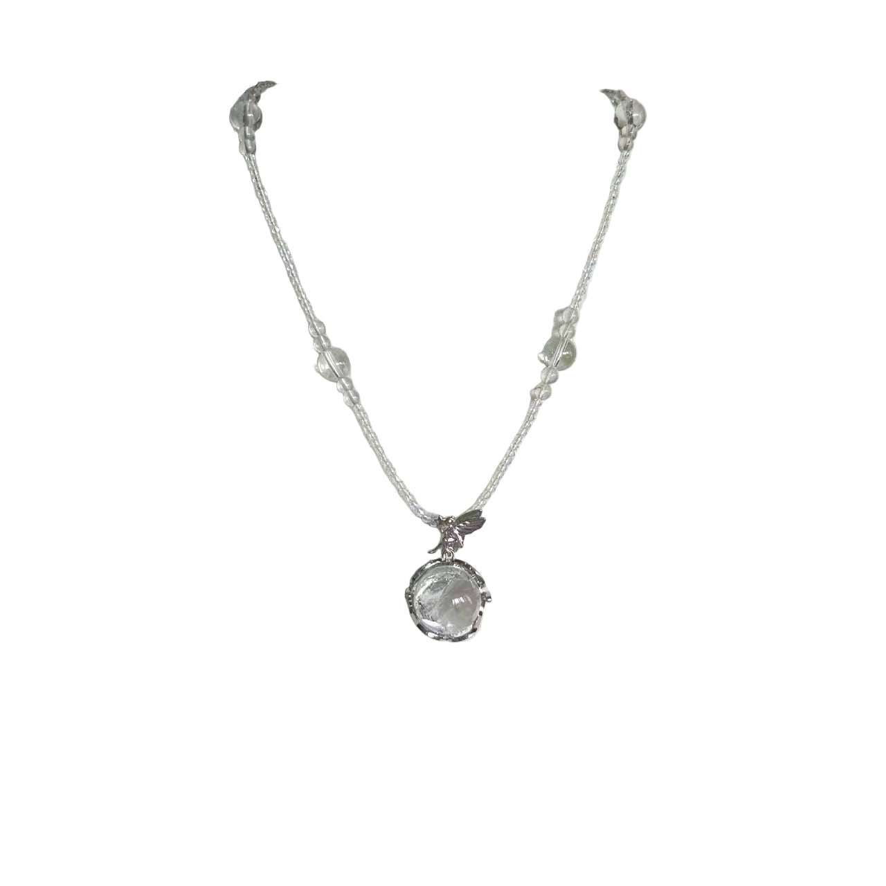 Silver necklace with a clear pendant on a white mannequin bust.