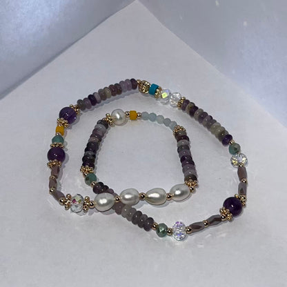 Set of beaded bracelets with pearls on a white background