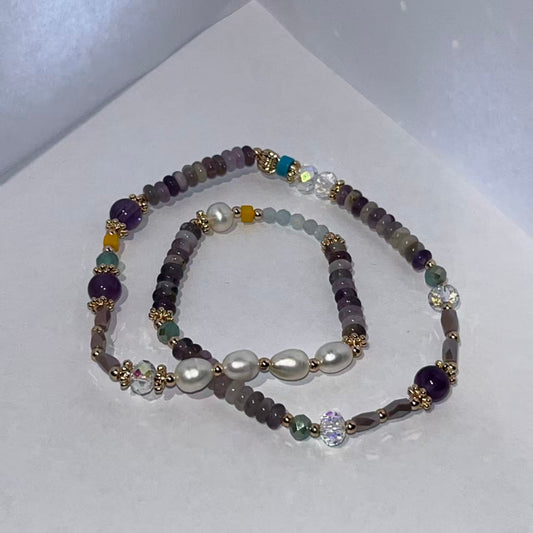 Set of beaded bracelets with pearls on a white background