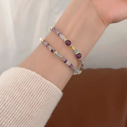 Beaded bracelet on a wrist with a neutral background