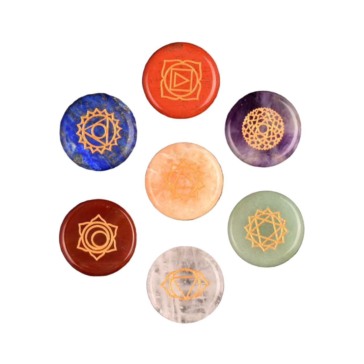 Set of seven chakra stones with geometric symbols on a white surface