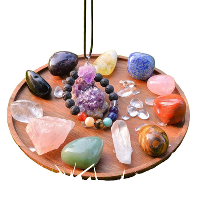 Wooden tray with various crystals and stones on a white background