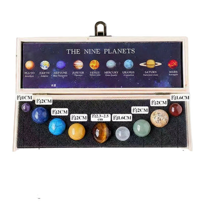 Model of the nine planets in a wooden box with labeled sizes on a white background