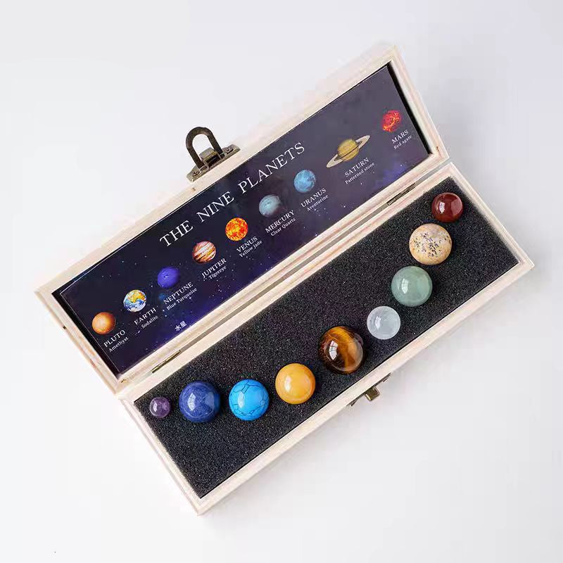 Set of nine planet models in a wooden box 