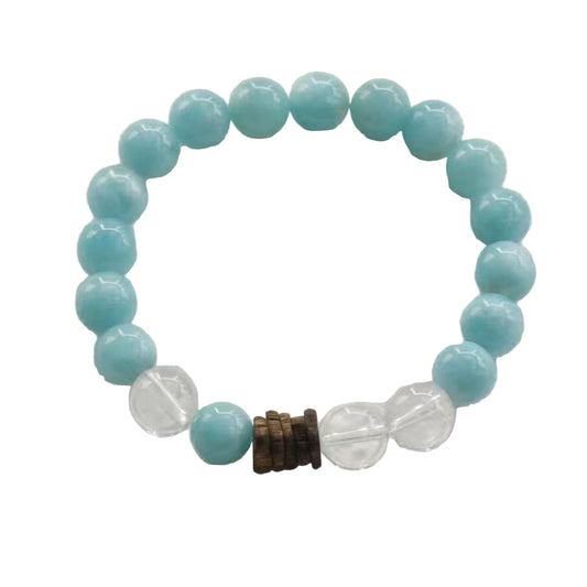 Turquoise beaded bracelet with a clear crystal and brown accent on a light gray background
