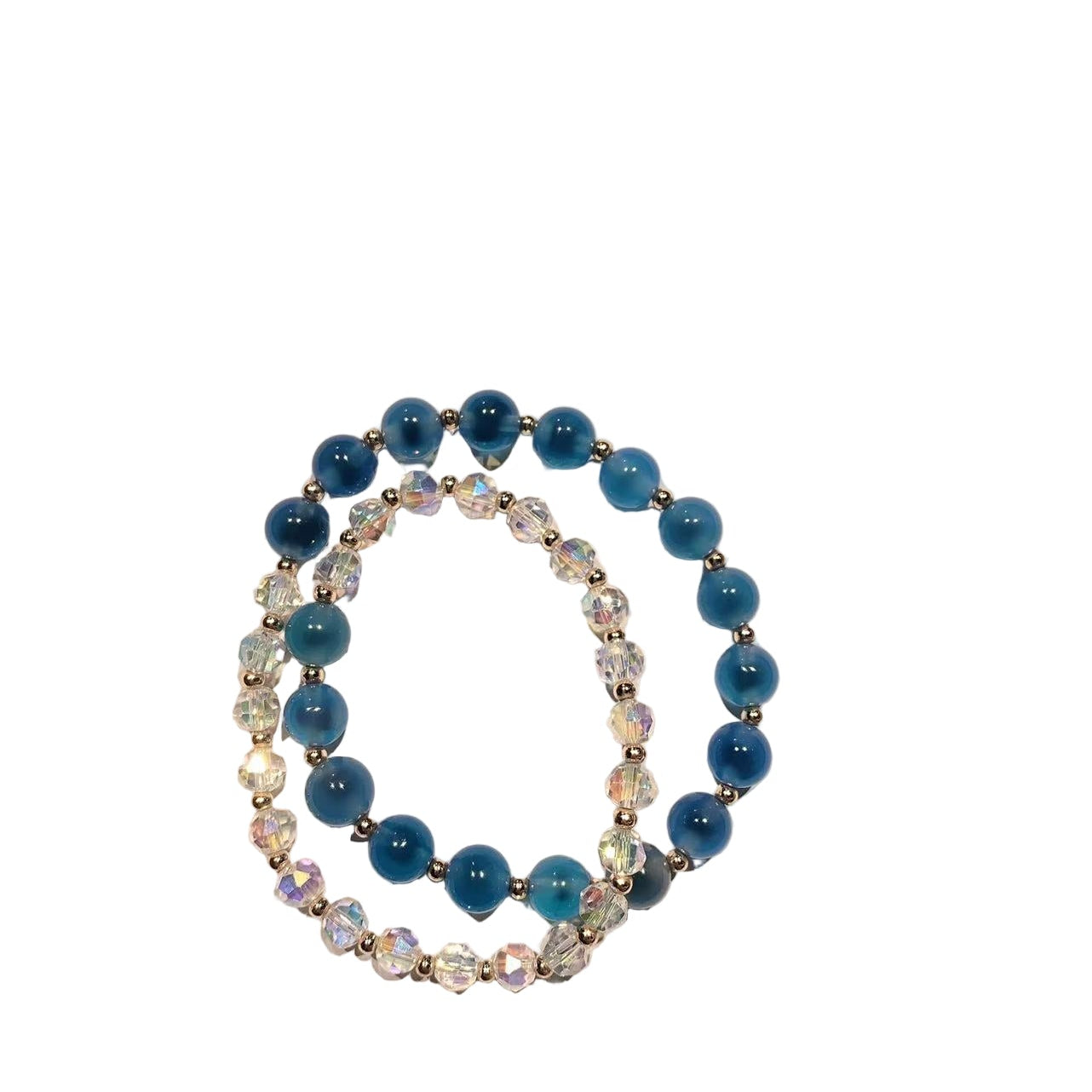 Stack of blue beaded bracelets on a beige background
