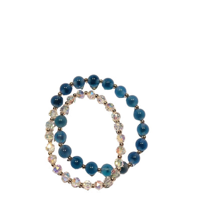 Stack of blue beaded bracelets on a beige background