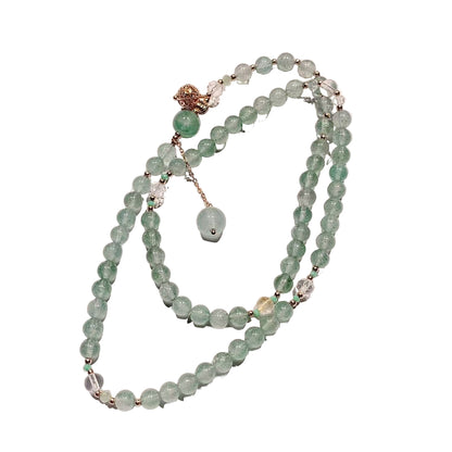 Green beaded necklace on a white  background