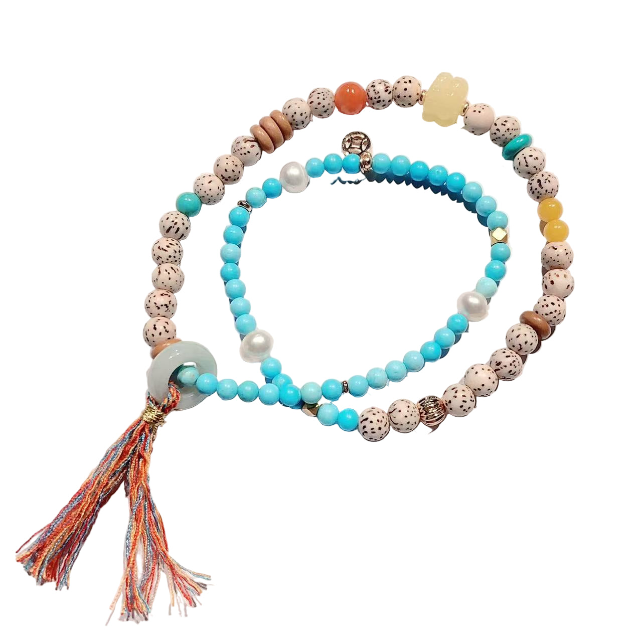 Set of beaded bracelets with tassels on a light background