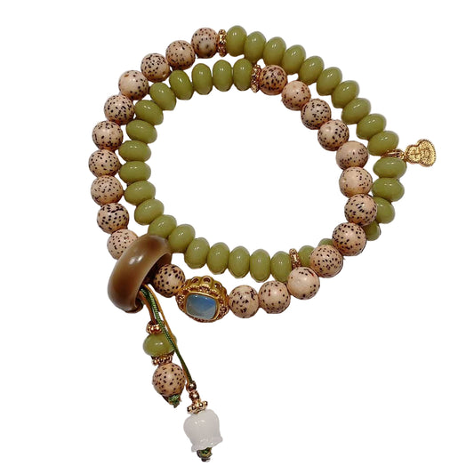 Beaded bracelet with green and brown beads on a white background