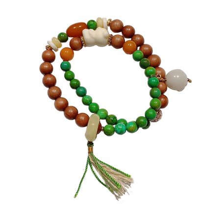 Beaded bracelet with green, brown, and white beads on a light background