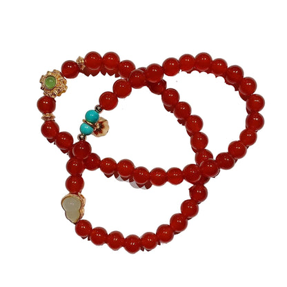 Red beaded bracelet with colorful beads on a white background
