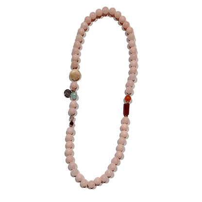 Necklace with pink beads and colorful accents on awhite background