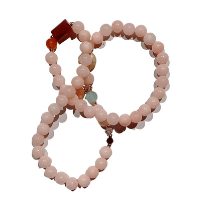 Beaded bracelet with pink, brown, and turquoise beads on a white background