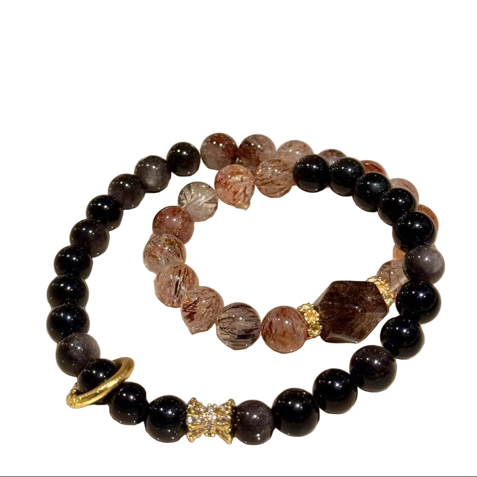 Set of beaded bracelets on a white plate with a light background