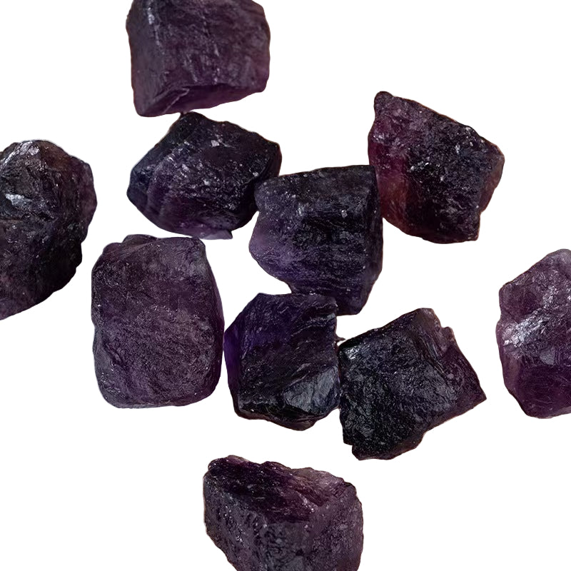 Purple crystal stones on a white surface