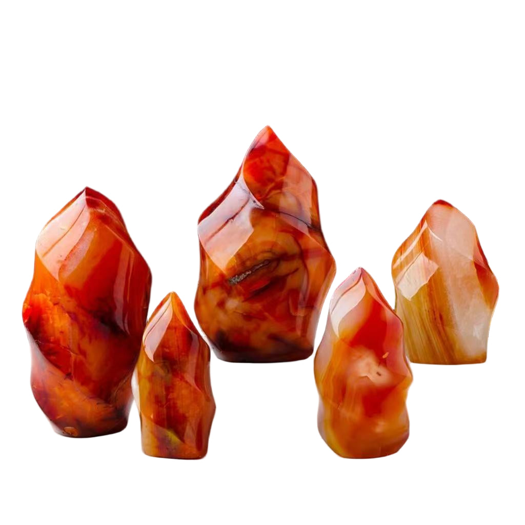 Five red and orange crystal-like objects on a white platform with a white background