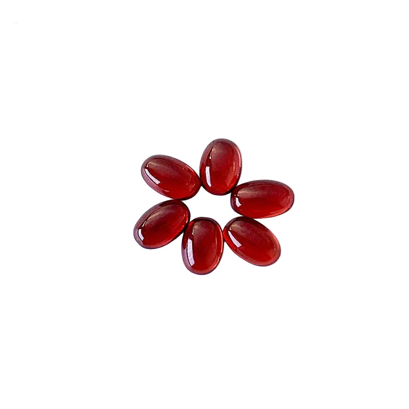 Red gemstones arranged in a circular pattern on a white background