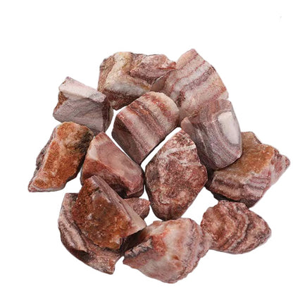 Raw red stones on a white surface 